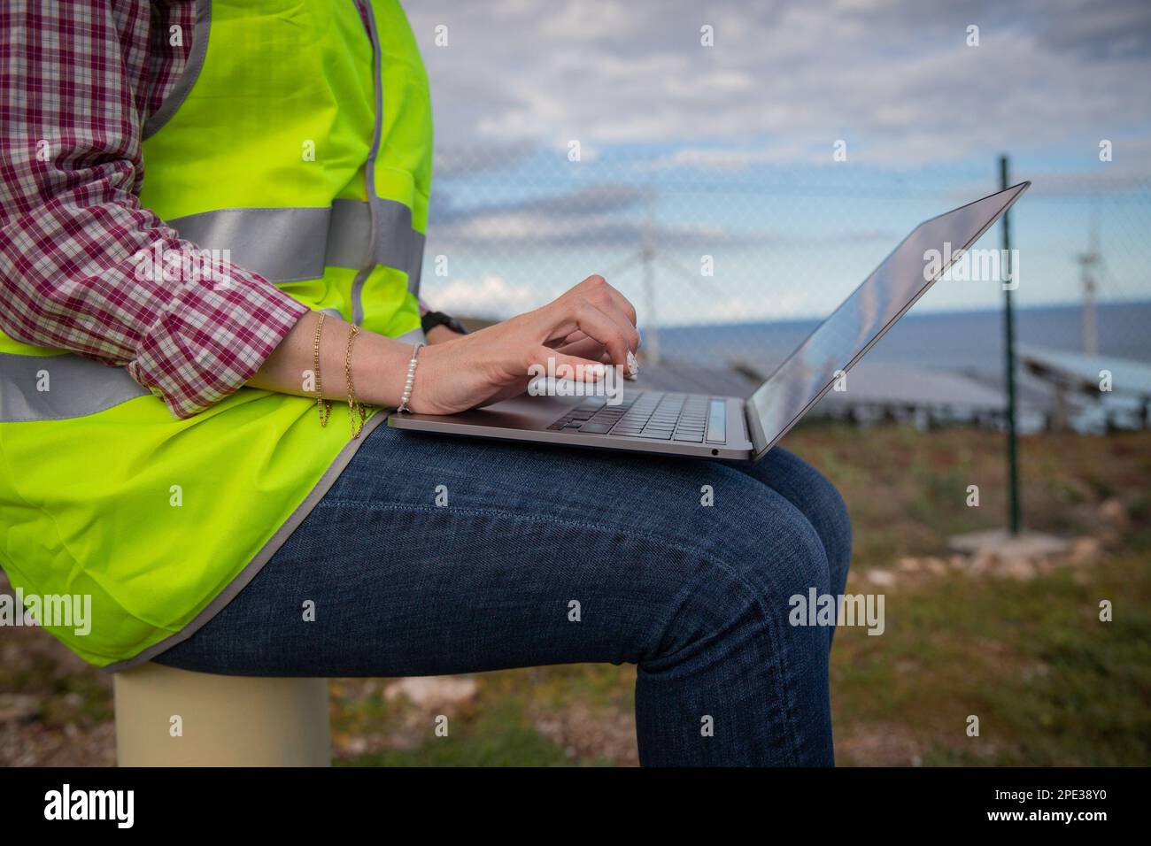 Un ingegnere utilizza il suo computer portatile in una centrale solare, foto con spazio di copia. Foto Stock Un ingegnere utilizza il suo computer portatile in una centrale solare, foto con spazio di copia. Foto Stock