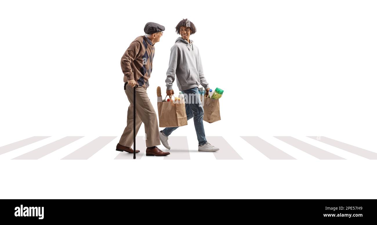 Giovane uomo afroamericano che aiuta un anziano con borse di alimentari in un passaggio pedonale isolato su sfondo bianco Foto Stock