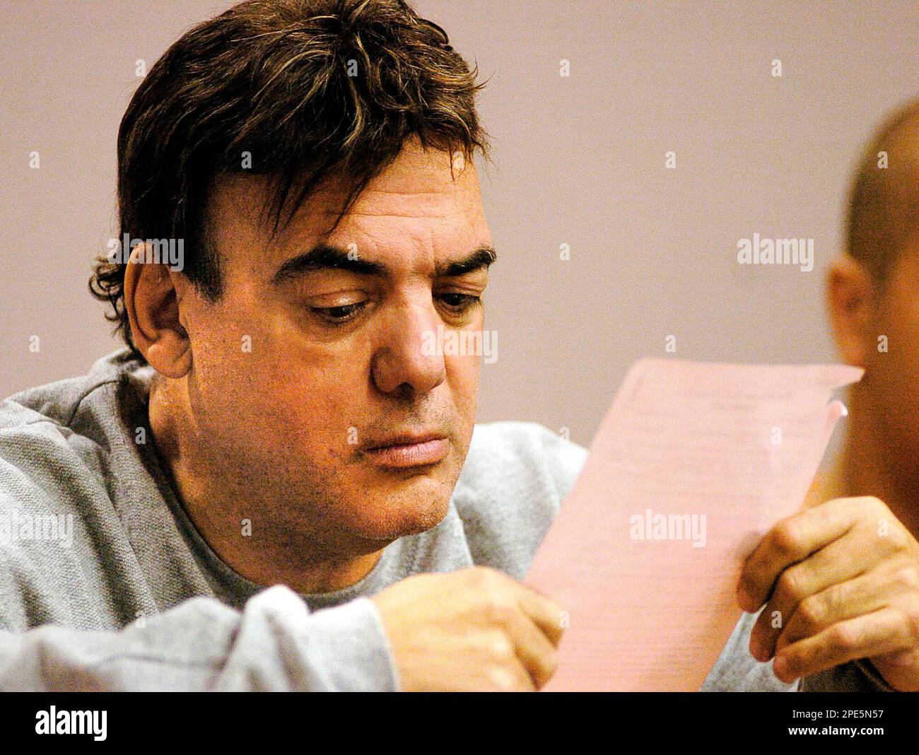 Ronald Pasqualino reads court documents prior to his appearance in