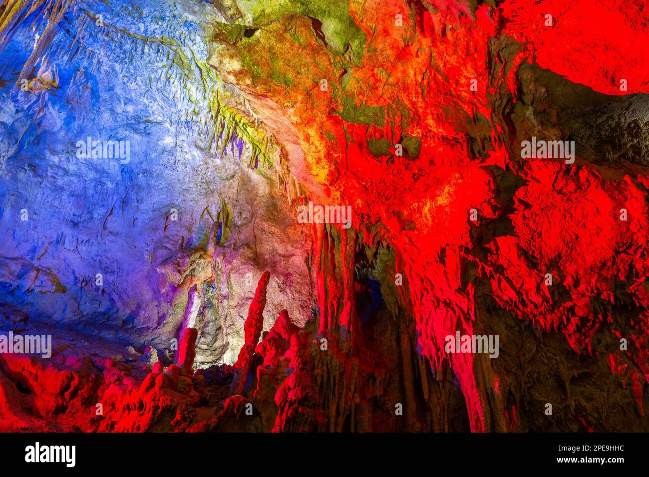 Monumento naturale della Grotta di Prometheus, Kutaisi, Georgia, con tende in pietra pensile, stalattiti e stalagmiti, colorate formazioni rocciose illuminate. Foto Stock