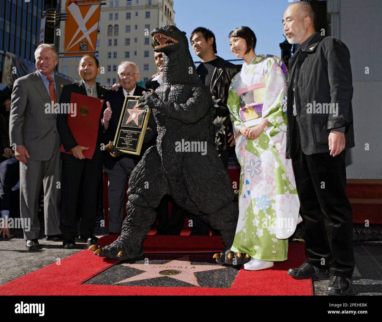 Film character 'Godzilla', center, poses with, from left, Los Angeles Film character 'Godzilla', center, poses with, from left, Los Angeles
