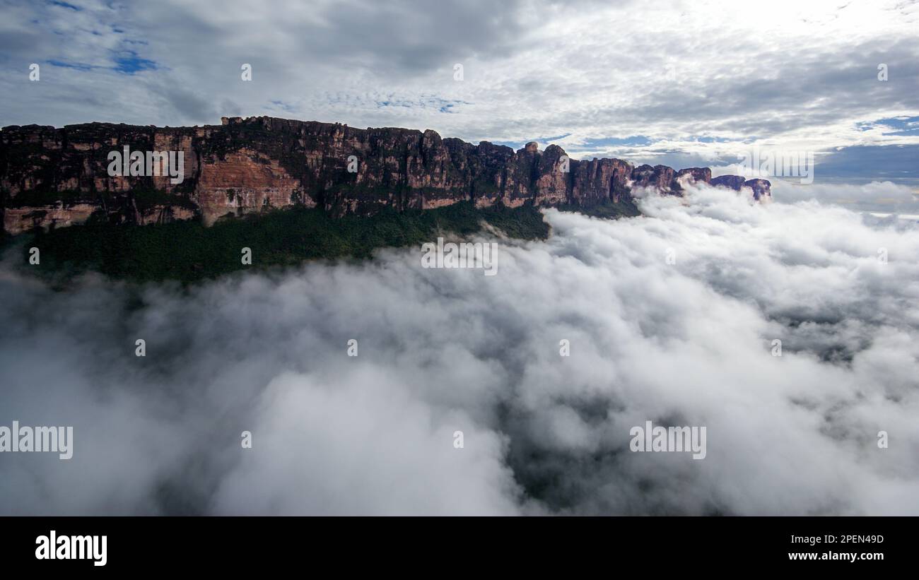 Torreggianti scogliere di arenaria di Auyan Tepui all'alba con nuvole sopra la Gran Sabana, Venezuela Foto Stock