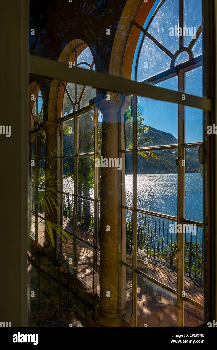 Patio con colonna nel bosco sul lato della montagna e cielo azzurro e lago di Lugano nel Parco Scherrer di Morcote, Ticino, Svizzera. Foto Stock Patio con colonna nel bosco sul lato della montagna e cielo azzurro e lago di Lugano nel Parco Scherrer di Morcote, Ticino, Svizzera. Foto Stock