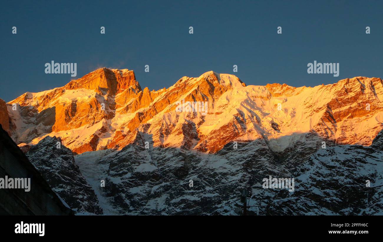 Montagna coperta di neve che splende con i raggi del sole in Himalaya. Gli Himalaya sono sede di alcune delle località più esotiche del mondo, con la h Foto Stock
