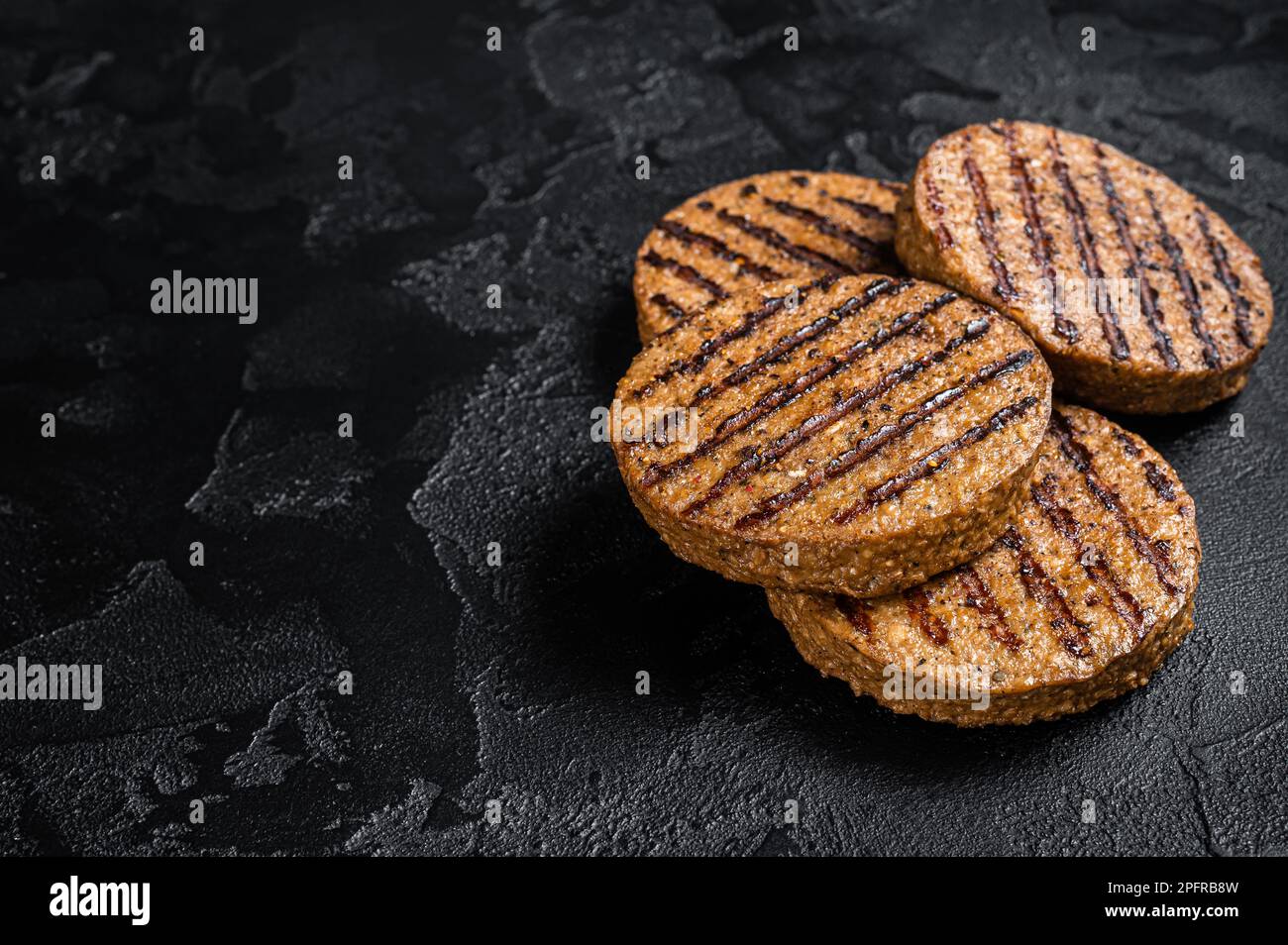 Polpette di carne grigliate, cotolette di carne a base di piante. Sfondo nero. Vista dall'alto. Spazio di copia. Foto Stock
