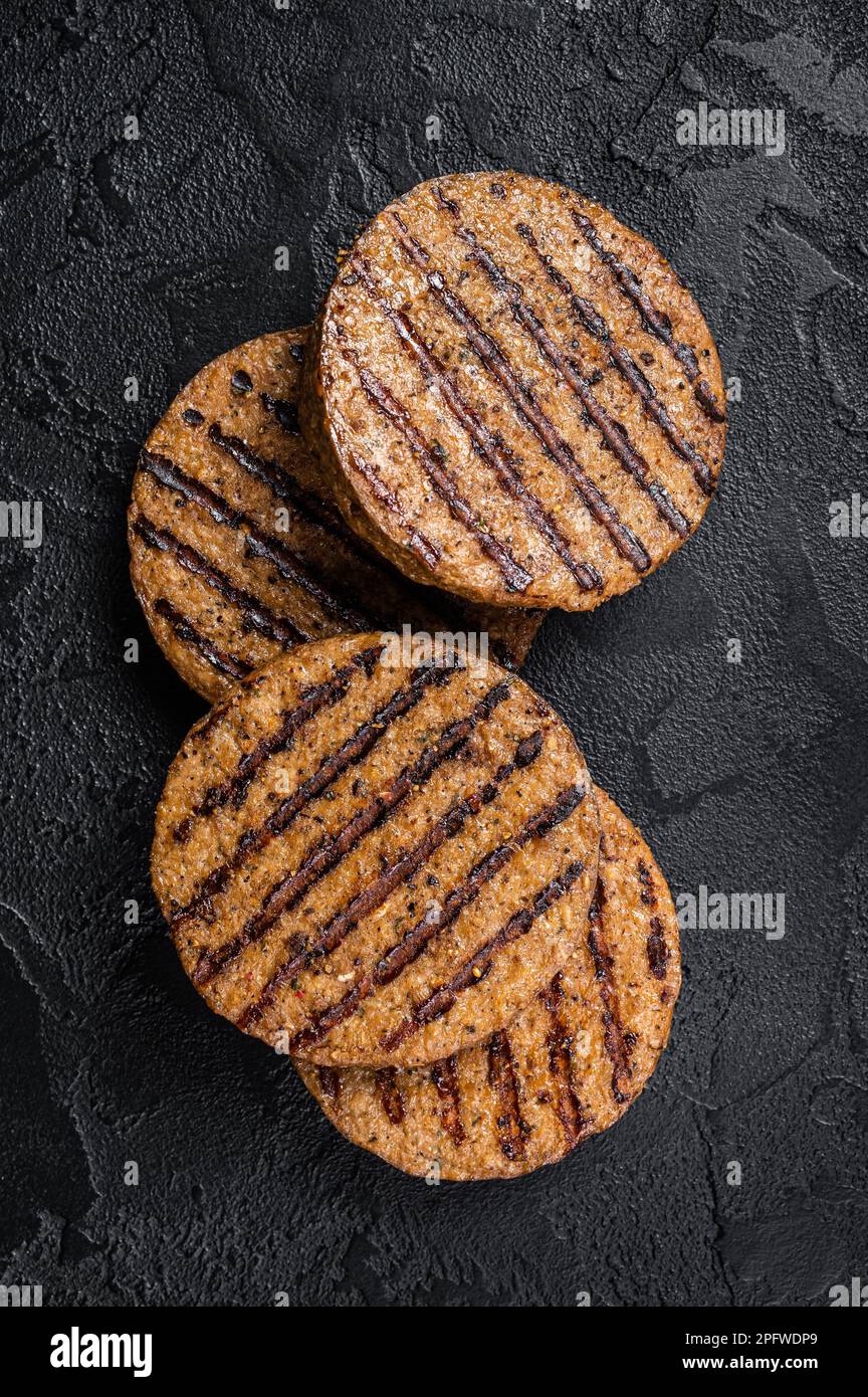 Polpette di carne grigliate, cotolette di carne a base di piante. Sfondo nero. Vista dall'alto. Foto Stock