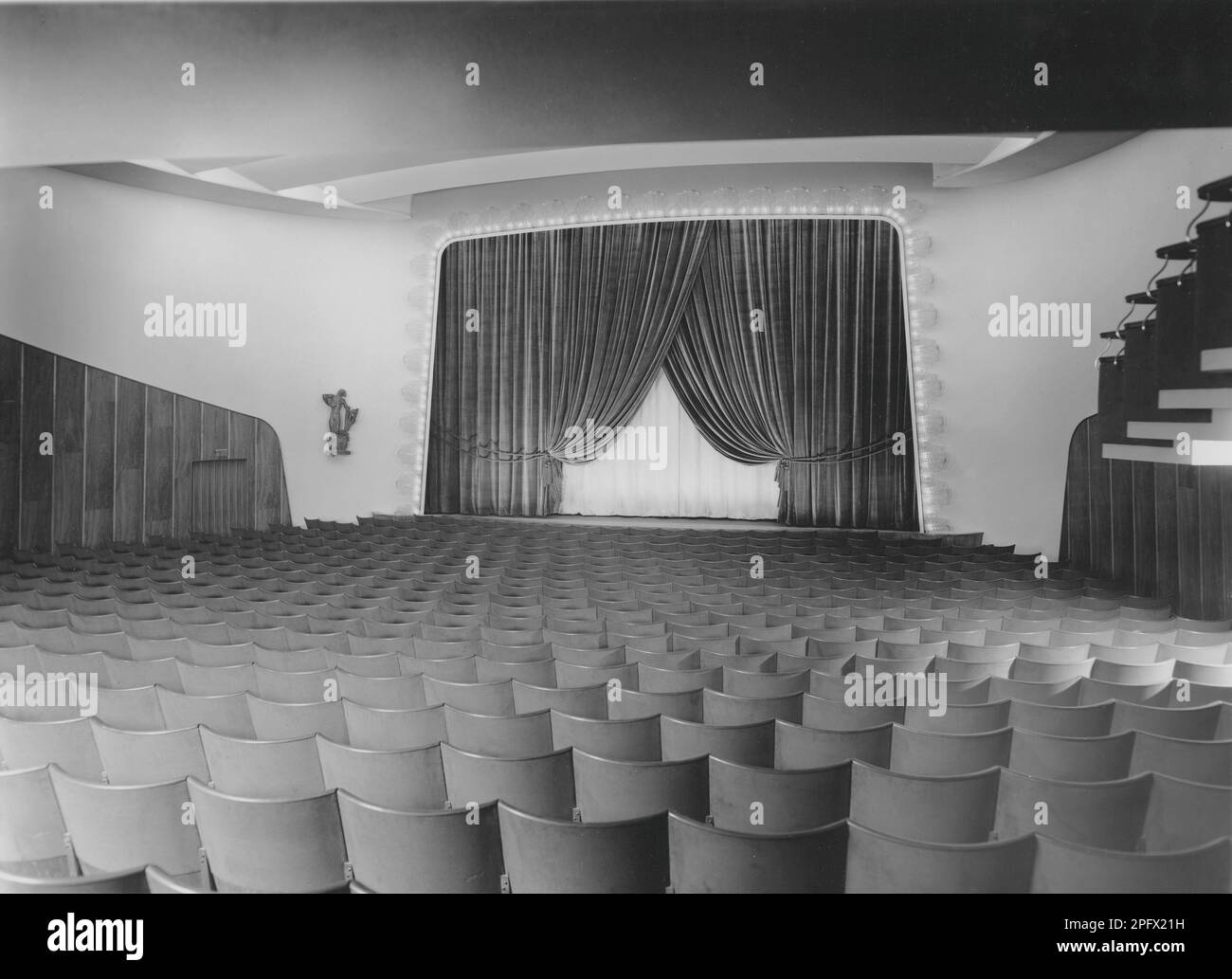 Cinema negli anni '1940s. Un interno di un tipico cinema con posti a sedere vicino allo schermo del film e sul balcone. Lo schermo è parzialmente coperto da tende. Svezia 1940s Foto Stock