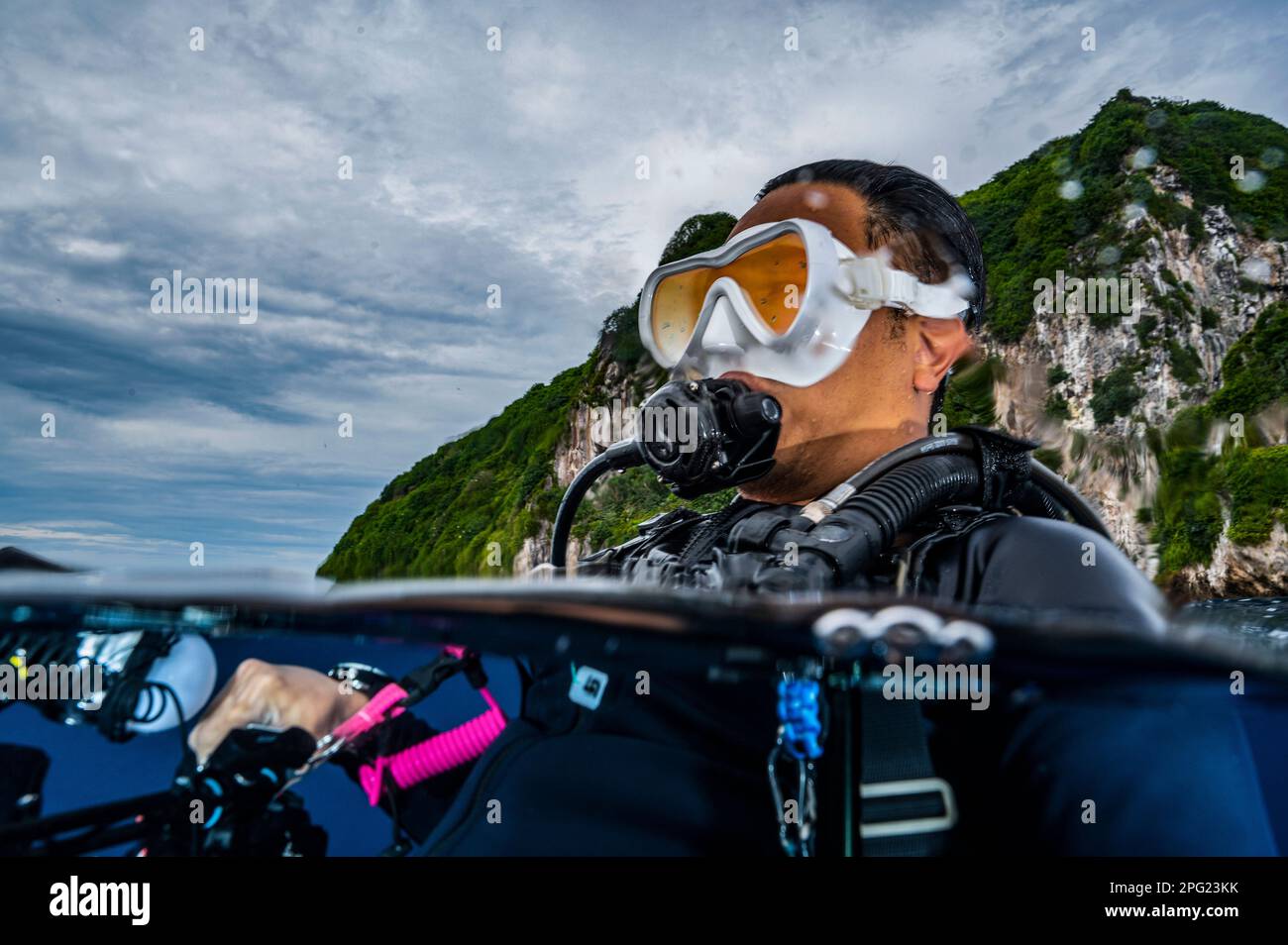 Tuffatore che si affaccia sulle acque tropicali del mare di banda Foto Stock