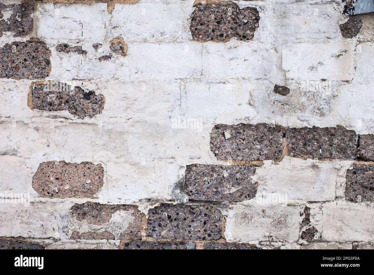 Vecchio mattone bianco sfondo grigio parete. Struttura in pietra leggera. Foto Stock
