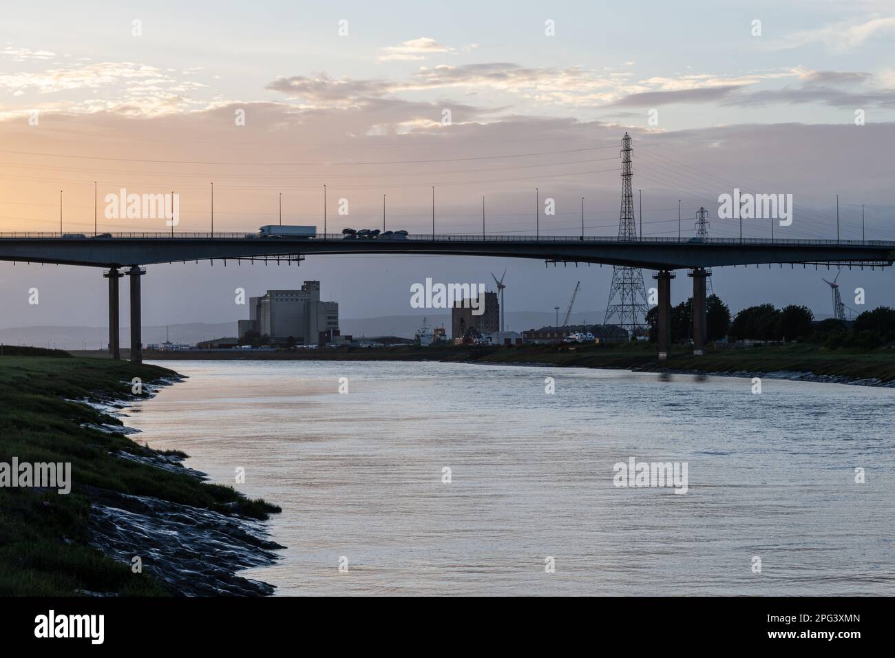 Il traffico attraversa l'estuario del fiume Avon sul ponte Avonmouth dell'autostrada M5 al crepuscolo a Bristol, Inghilterra. Foto Stock
