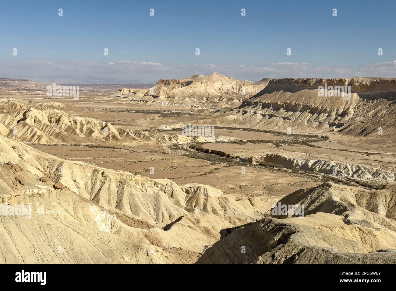 Guardando giù sul torrente nahal wadi Zin che serpeggiante attraverso la valle di Zin davanti al monte di Hod Akev vicino a Sde Boker in Israele con un cielo blu chiaro Foto Stock