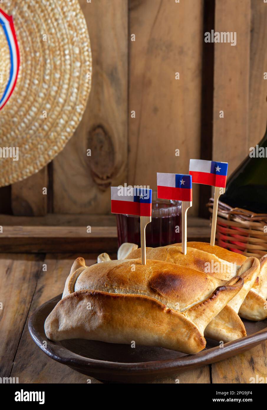 Concetto di giorno di indipendenza del Cile. fiestas patrias. Empanadas de pino al forno, vino o chicha, cappello e gioco a emboque. Piatto e bevanda su 18 Foto Stock