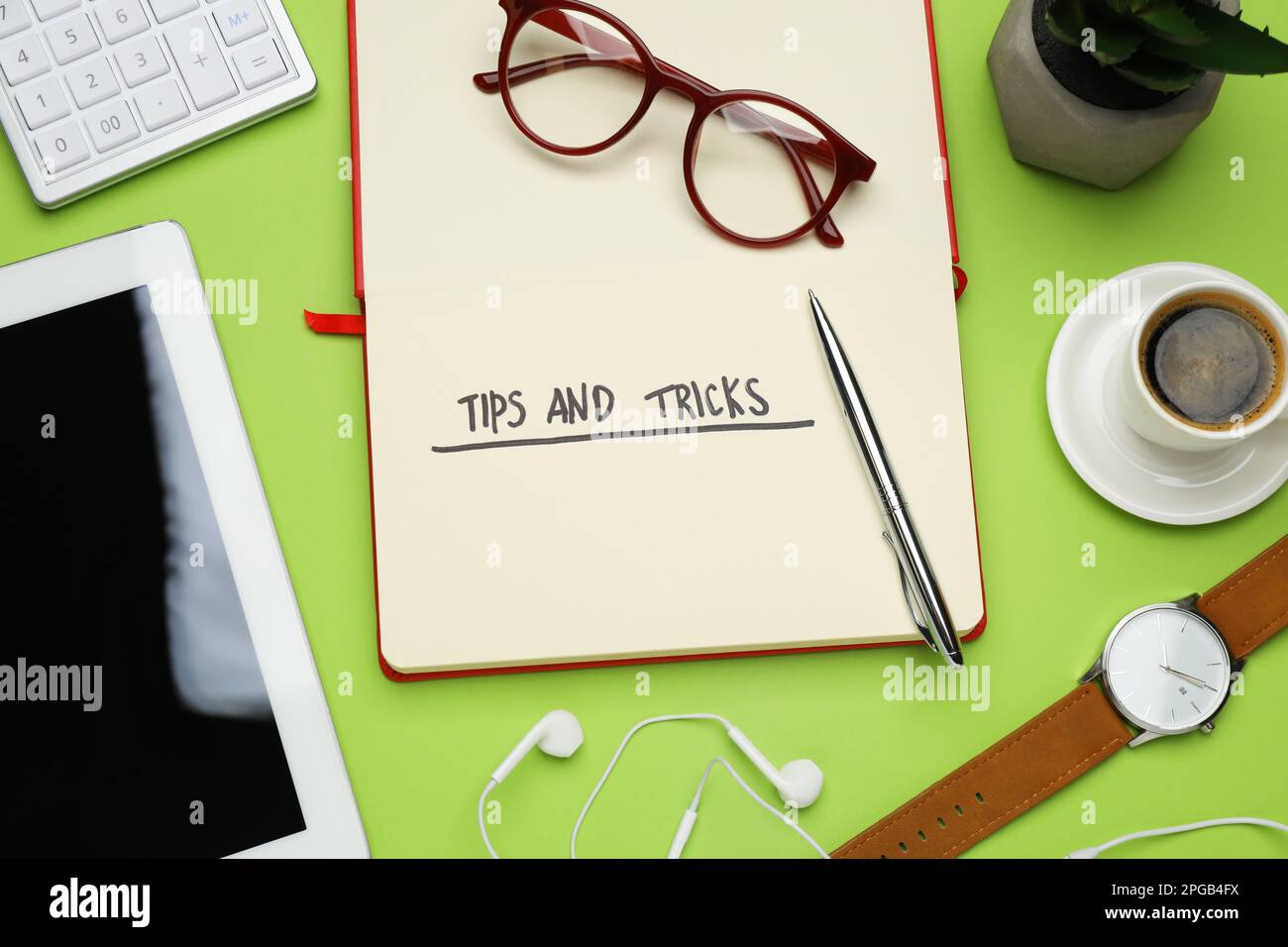 Composizione a posa piatta con notebook su sfondo verde. Suggerimenti e trucchi Foto Stock
