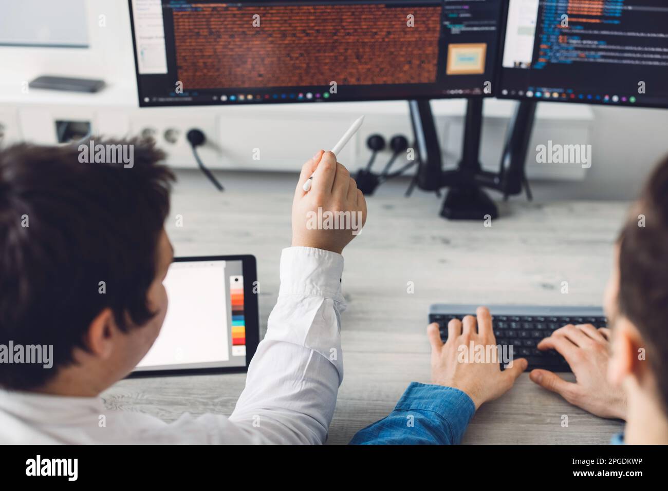 Vista ravvicinata di due programmatori che sviluppano una nuova app al lavoro Foto Stock