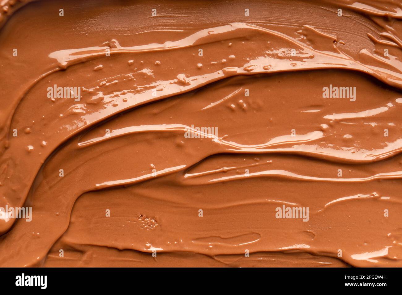 Sfondo cioccolato. Cioccolato fuso. Cioccolato al latte liquido. Cioccolato fatto a mano. Foto Stock