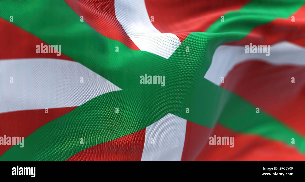 La bandiera dei Paesi Baschi sventola. Comunità autonoma nel nord della Spagna. Croce bianca su un salito verde su un campo rosso. Messa a fuoco selettiva. 3d illustrat Foto Stock