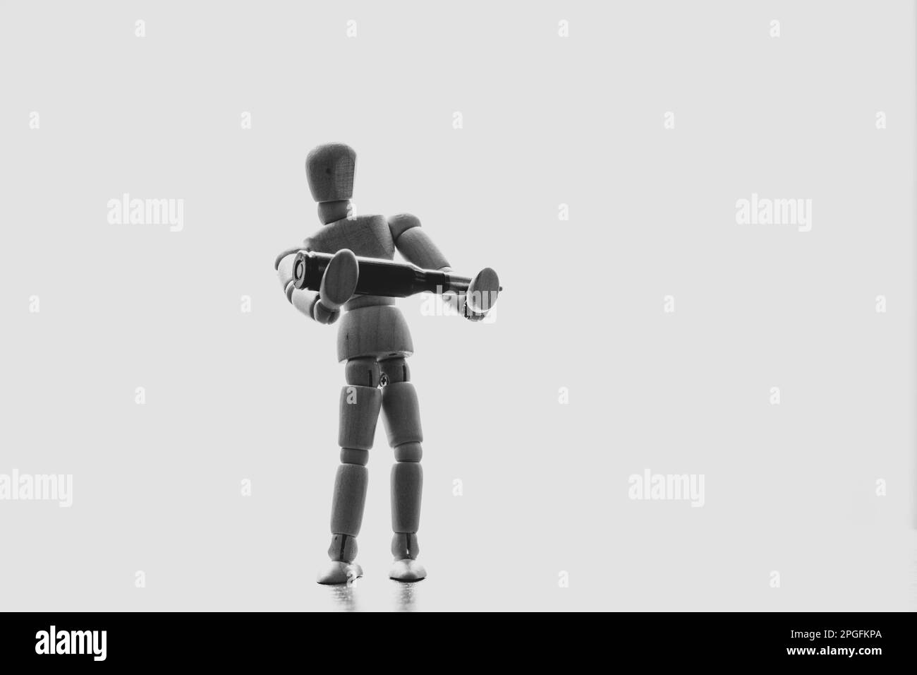 Pupazzo di legno che tiene un proiettile in primo piano alla luce del sole Foto Stock