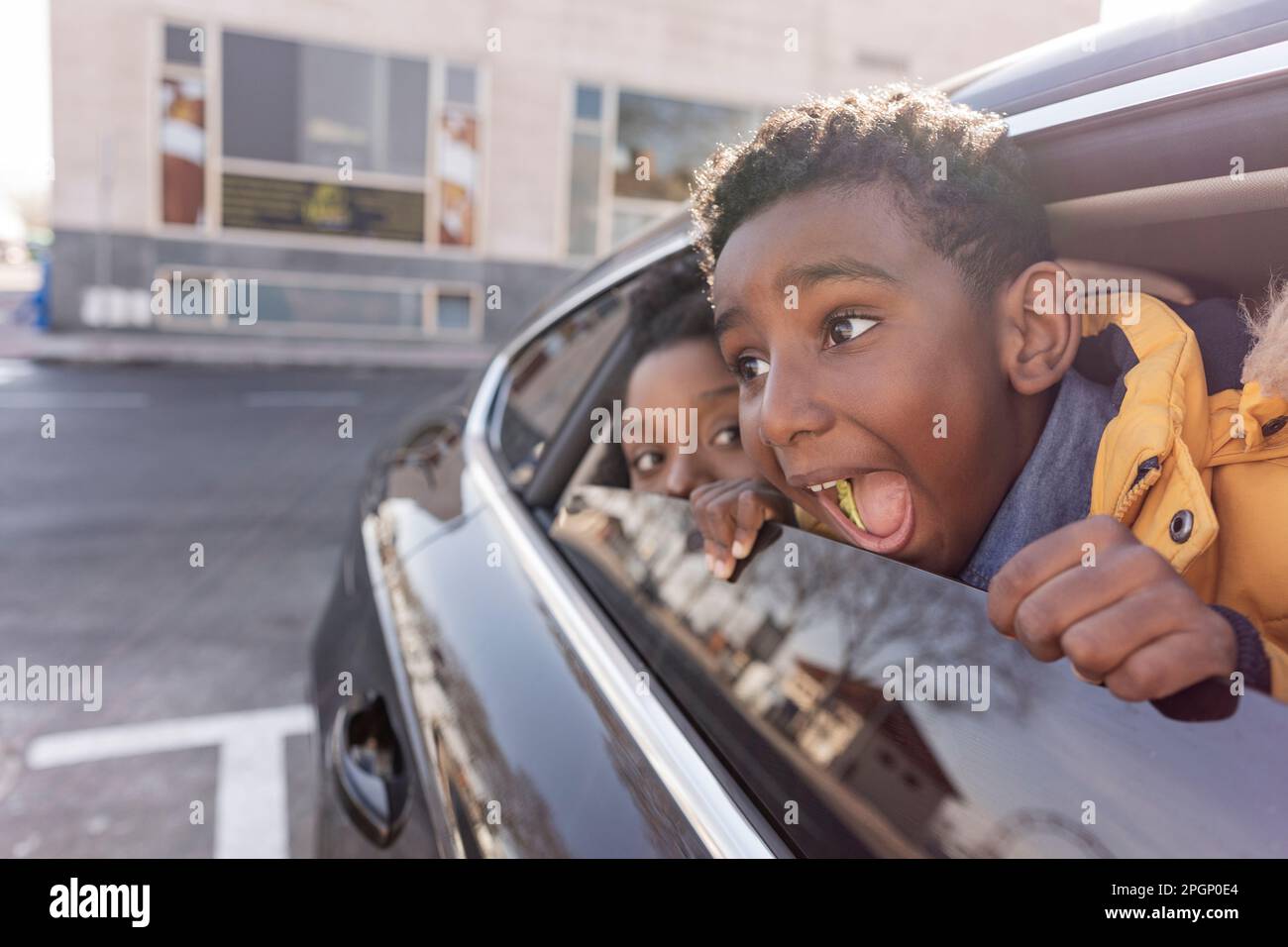 Felice ragazzo con madre che urla in macchina Foto Stock