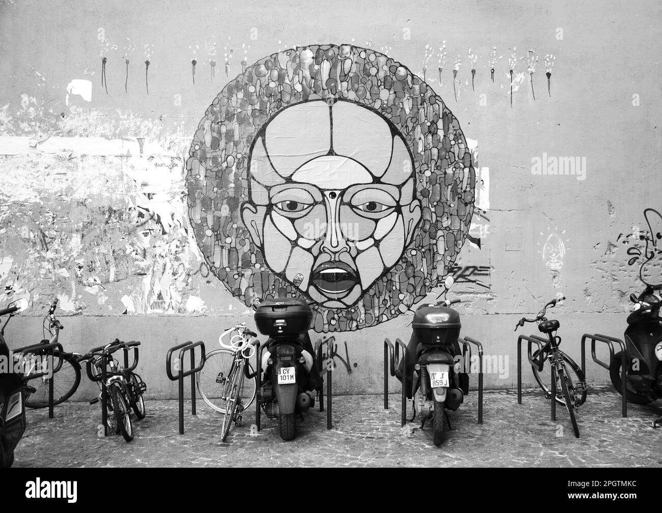 Parigi, Francia - 16 marzo 2016: Alieni in città. Scena urbana con Street art, biciclette e morcicli vicino al Centro Georges Pompidou. Foto in bianco e nero Foto Stock