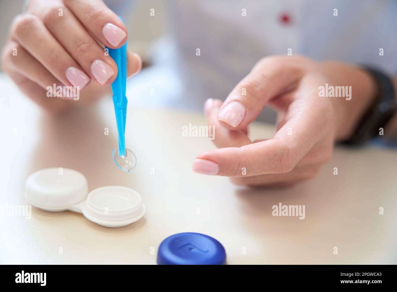 Primo piano di una persona non riconosciuta è in possesso di lenti trasparenti usa e getta Foto Stock