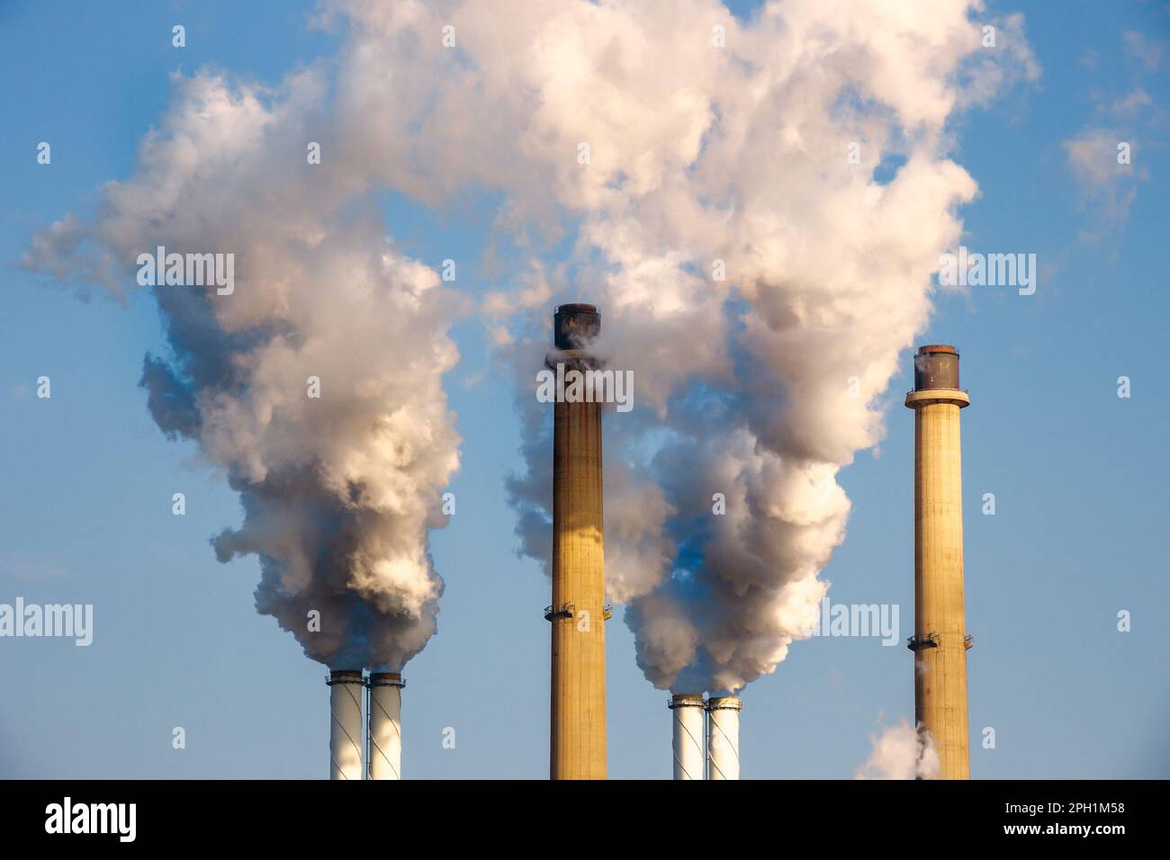 Tubi del camino di fumo di una centrale elettrica che causa inquinamento atmosferico. Foto Stock