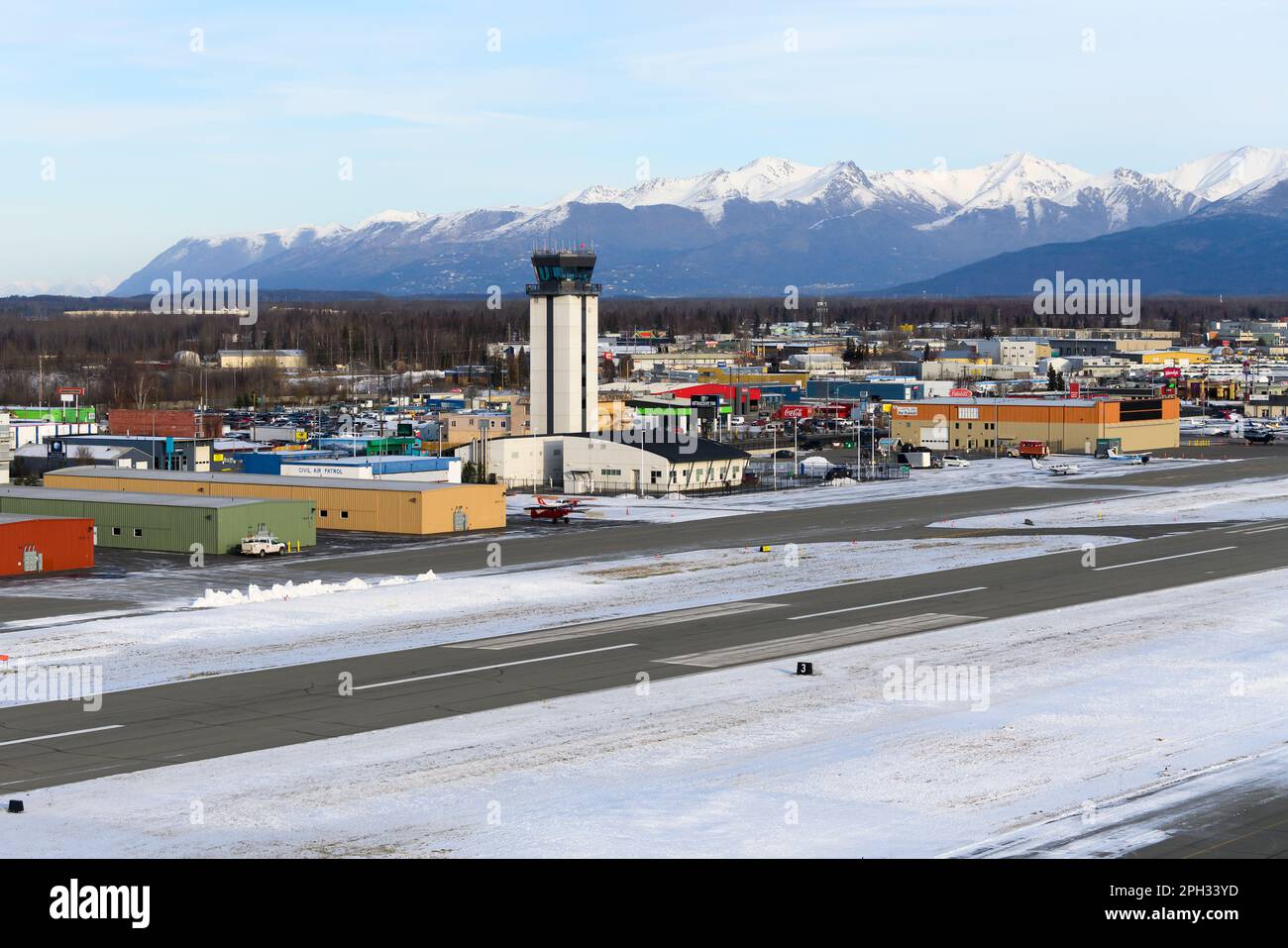 Merrill Field di Anchorage e il suo controllo del traffico aereo (torre ATC), utilizzato principalmente per l'aviazione generale. Merrill Field con le montagne dietro. Foto Stock