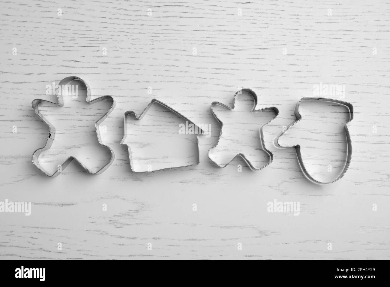 Taglierine per biscotti diverse su un tavolo di legno bianco, piatto Foto Stock