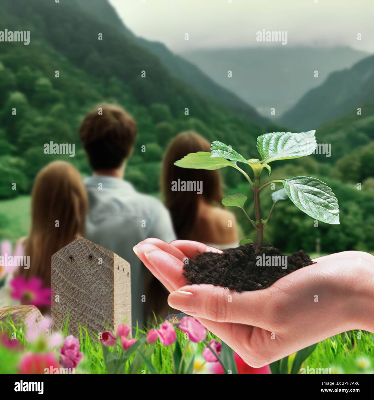 Concetto di ecologia - Un'immagine metaforica di una giovane famiglia che guarda con speranza ad un futuro idilliaco ed eco-sostenibile Foto Stock
