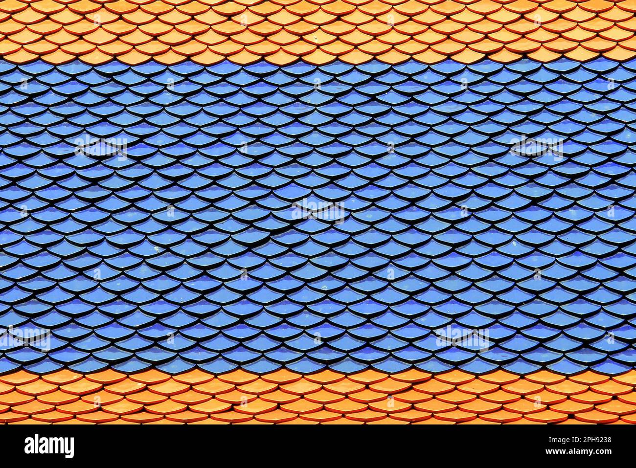 Tetto del tempio thailandese con tegole blu rosse in forma di scale di pesce al Palazzo reale di Bangkok, Thailandia. La migliore mattonella, bella materiali di finitura insolita Foto Stock