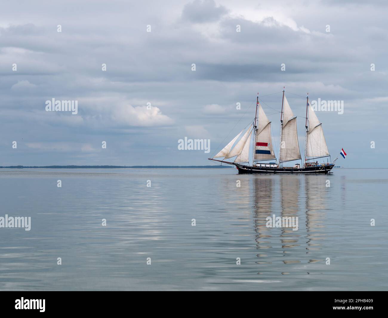 Tradizionale Clipper a tre alberi che naviga sul tranquillo lago Ijsselmeer, Paesi Bassi Foto Stock