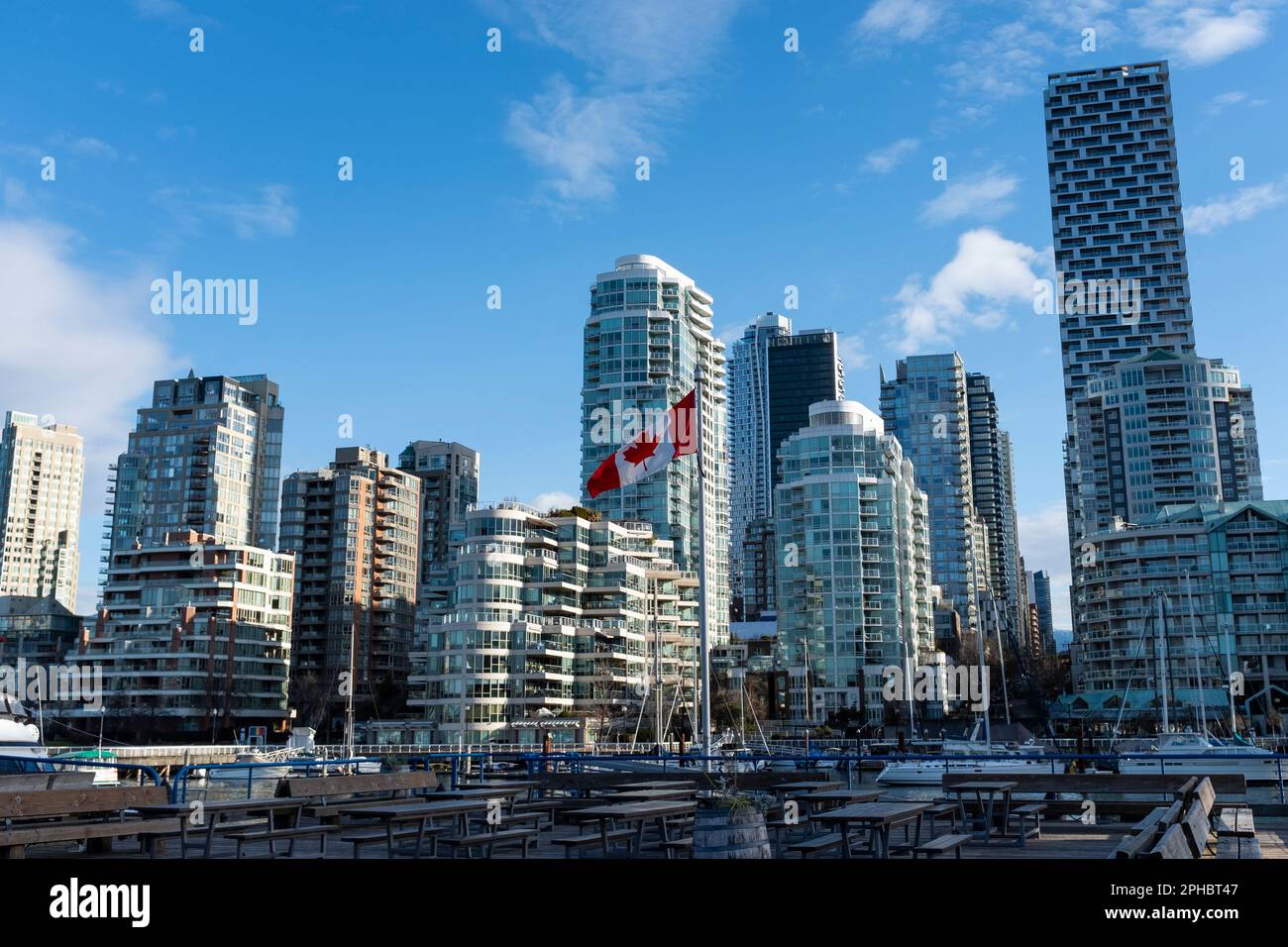 Alti condomini di lusso illuminati da una luminosa luce all'alba che si affaccia su False Creek e Granville Island a Vancouver, British Columbia, Canada Foto Stock