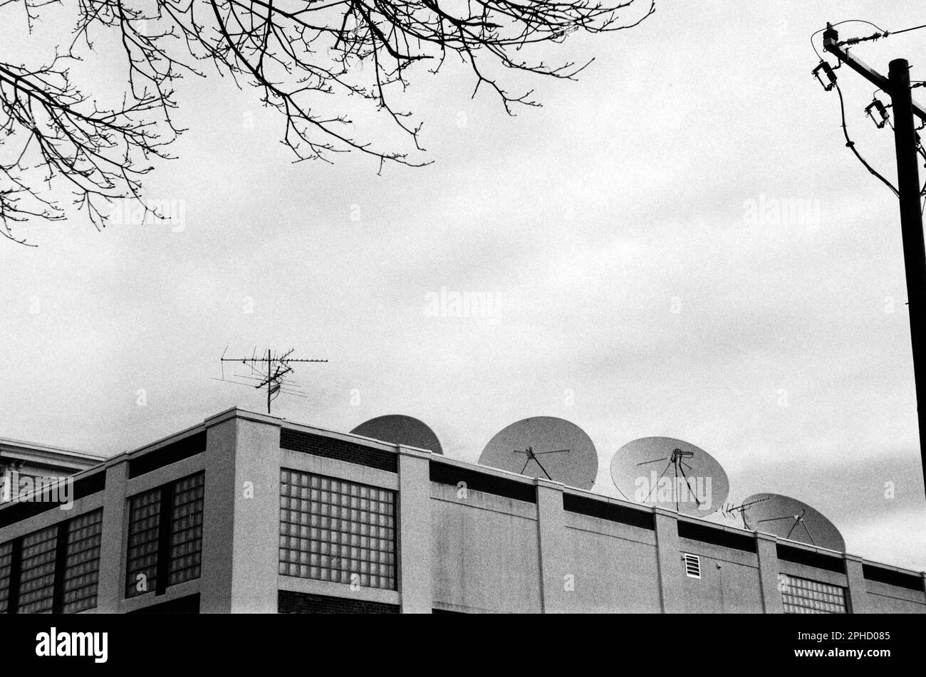 Una fila di parabole satellitari fiancheggiano il tetto di un edificio commerciale sulla Main St. Contro un cielo spettacolare a Stoneham, Massachusetts. L'immagine è stata acquisita Foto Stock