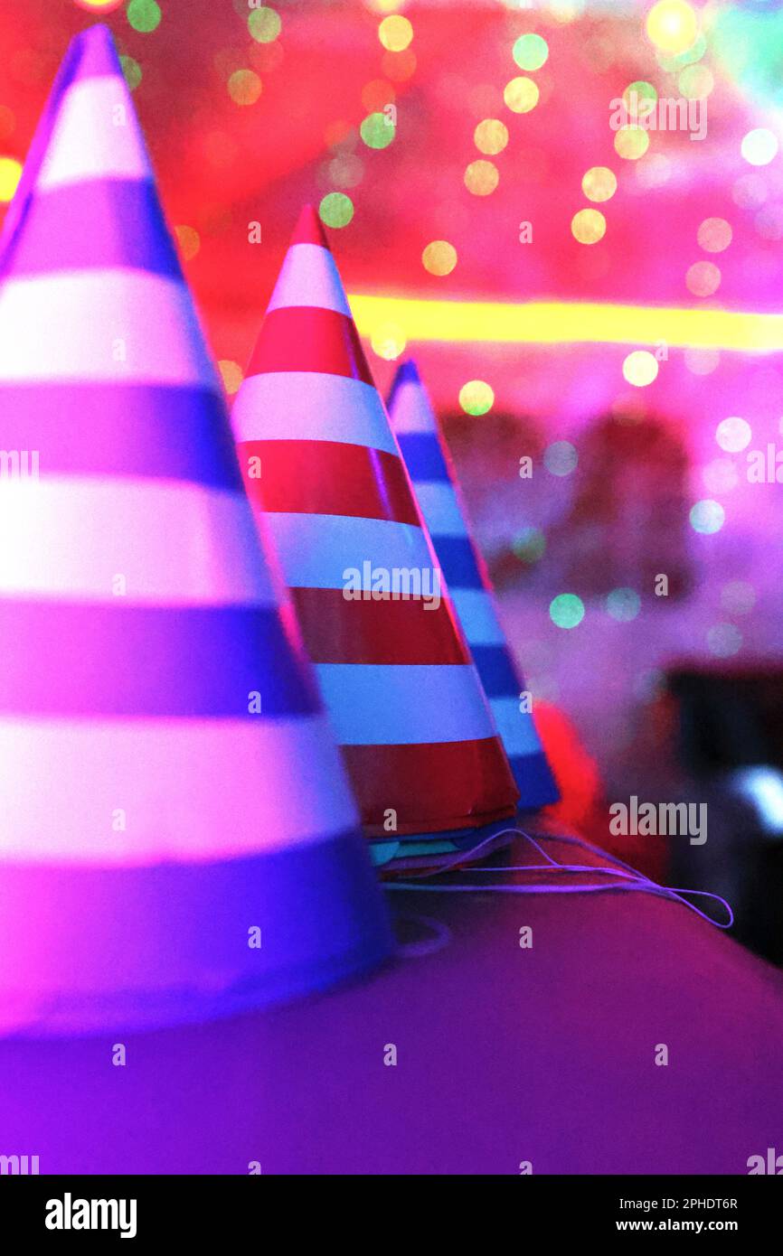 Foto d'arte casuale e fotografia di strada, ad una festa di compleanno ci sono cappelli colorati in una fila. Foto Stock