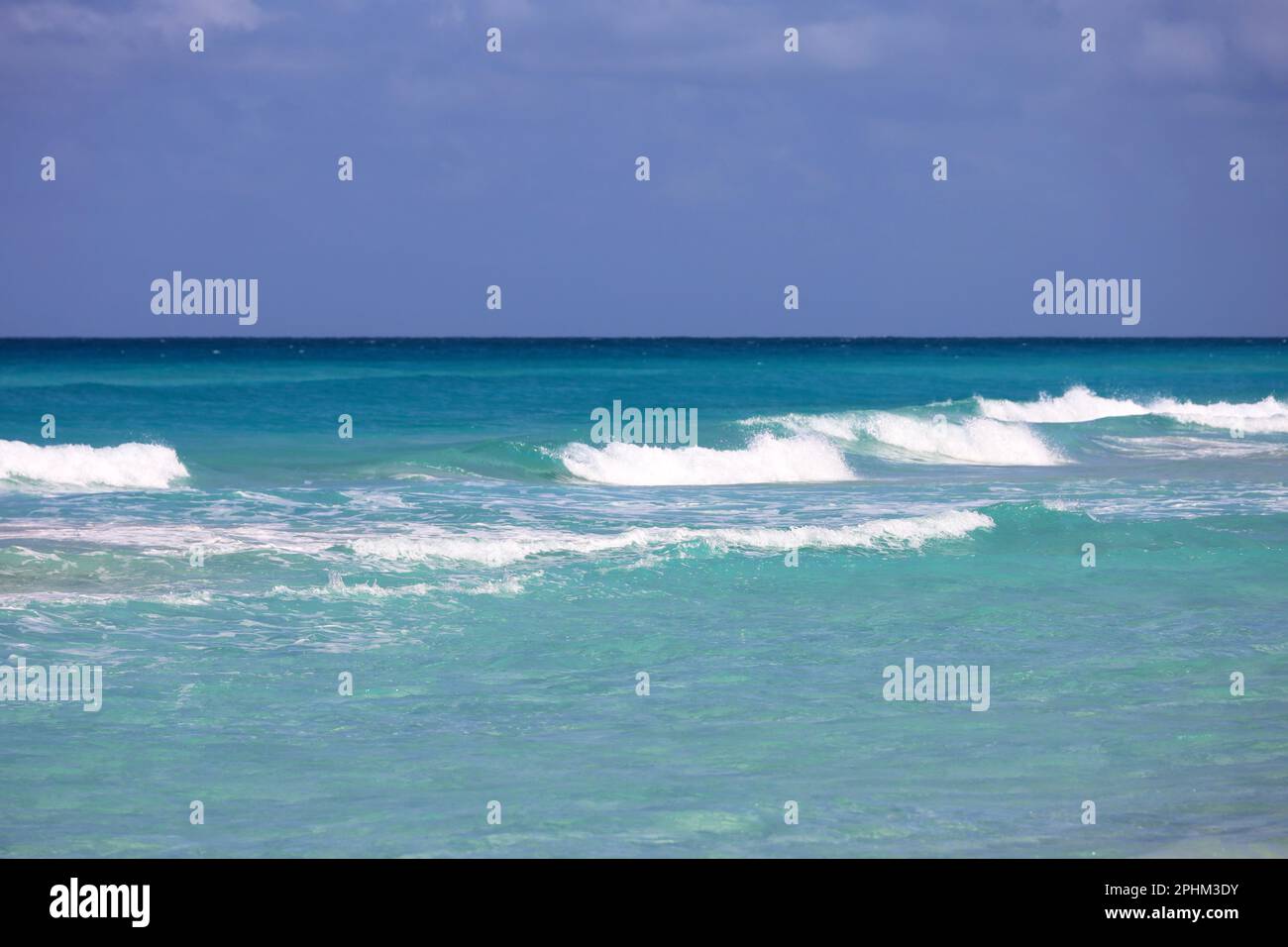 Vista sulle onde azzurre del mare e sul cielo blu. Costa dei Caraibi, sfondo per le vacanze sulla natura Foto Stock