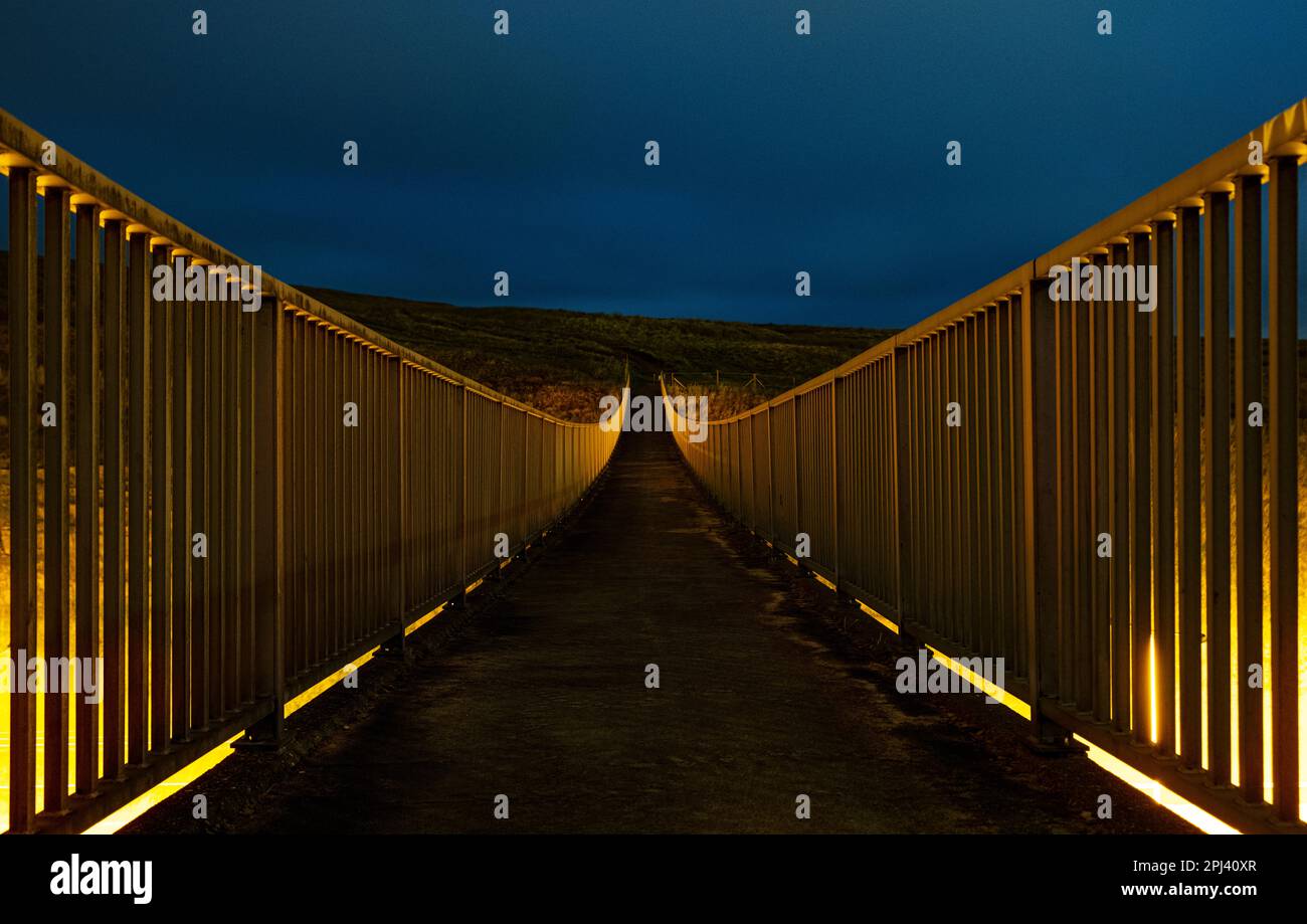 Ponte pedonale Pennine Way sull'autostrada M62 di notte. Vicino al confine tra Yorkshire e Lancashire e Windy Hill e Saddleworth Moor Foto Stock