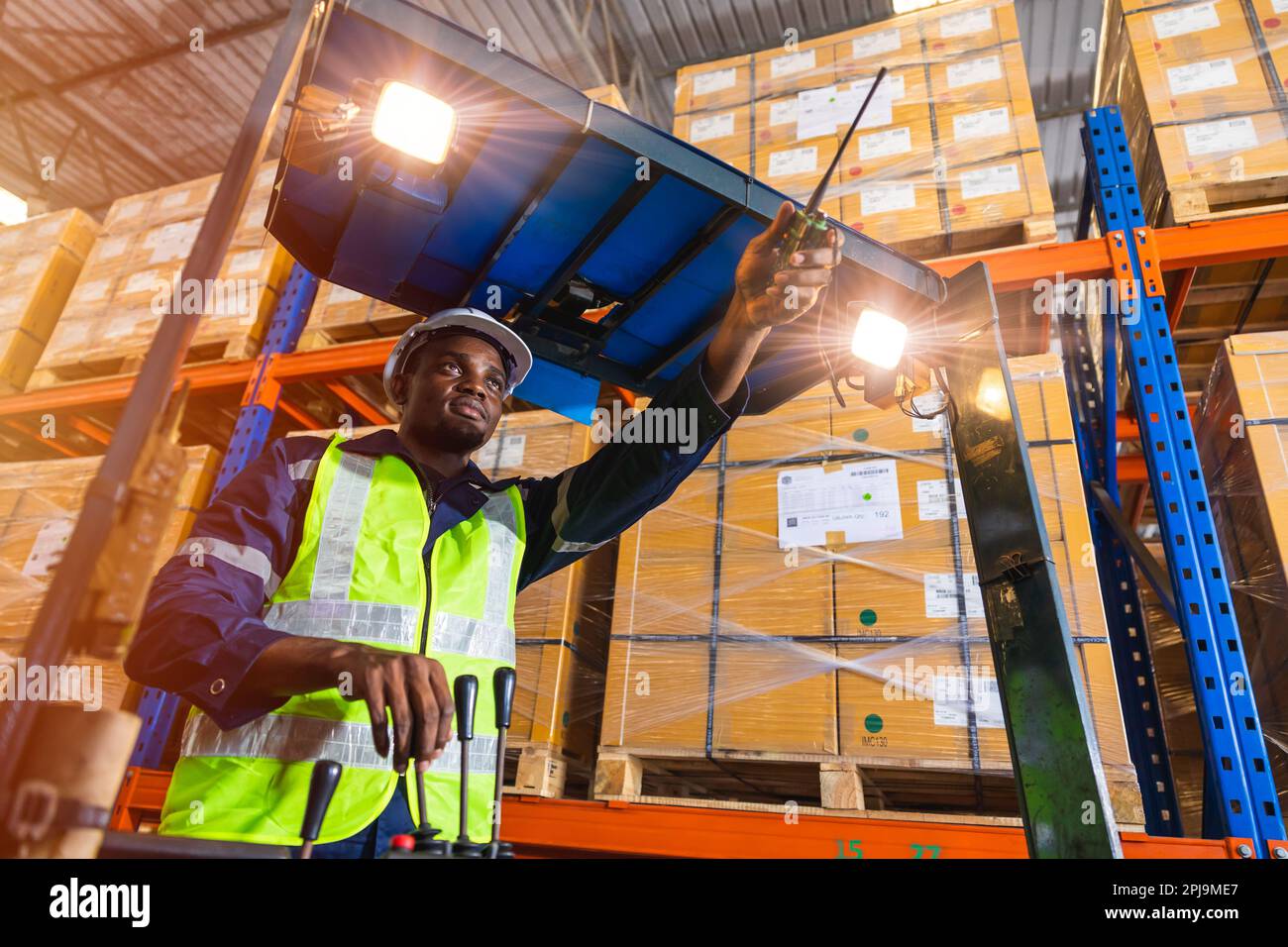 African nero maschio personale lavoratore controllo di lavoro carico di funzionamento folk ascensore in magazzino inventario fabbrica Foto Stock