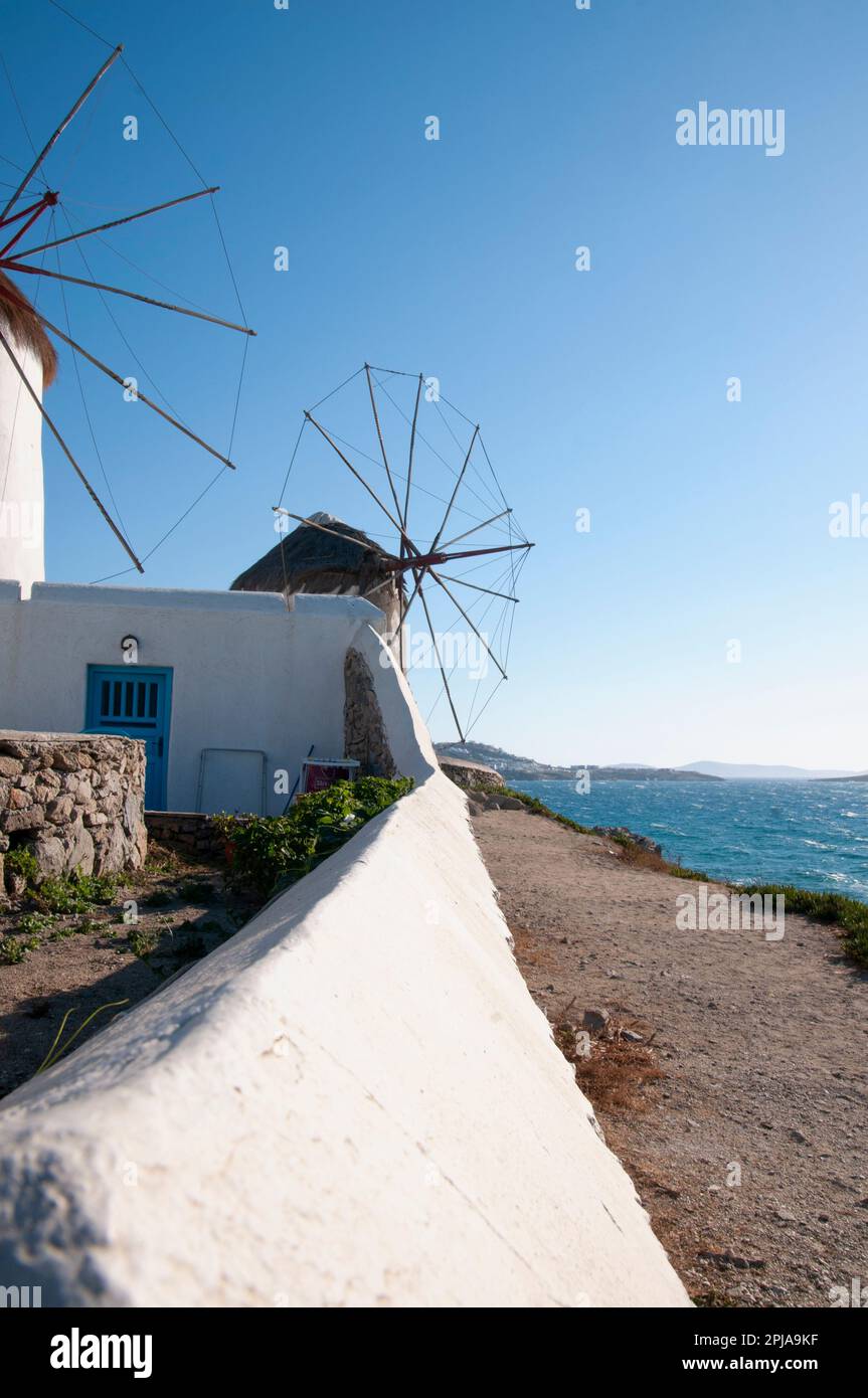 Vista verticale dei mulini a vento bianchi nell'isola di Mykonos contro il cielo blu. Questi storici e mulini sono una destinazione turistica per romantico e ho Foto Stock