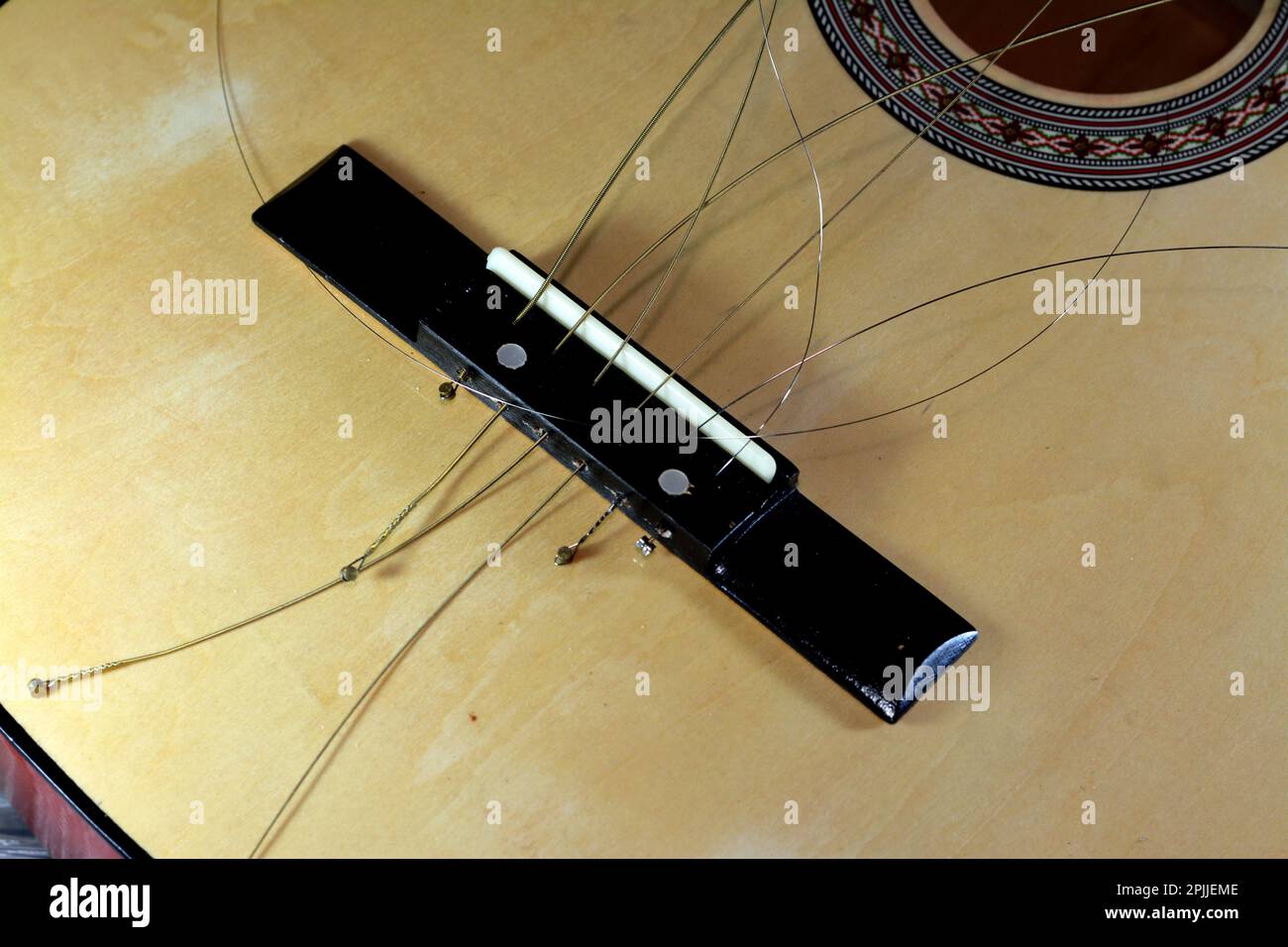 Una vecchia chitarra classica in legno rotta con corde danneggiate, strumento musicale frantumato, chitarra danneggiata non attaccata con corda tagliata e legno, selec Foto Stock