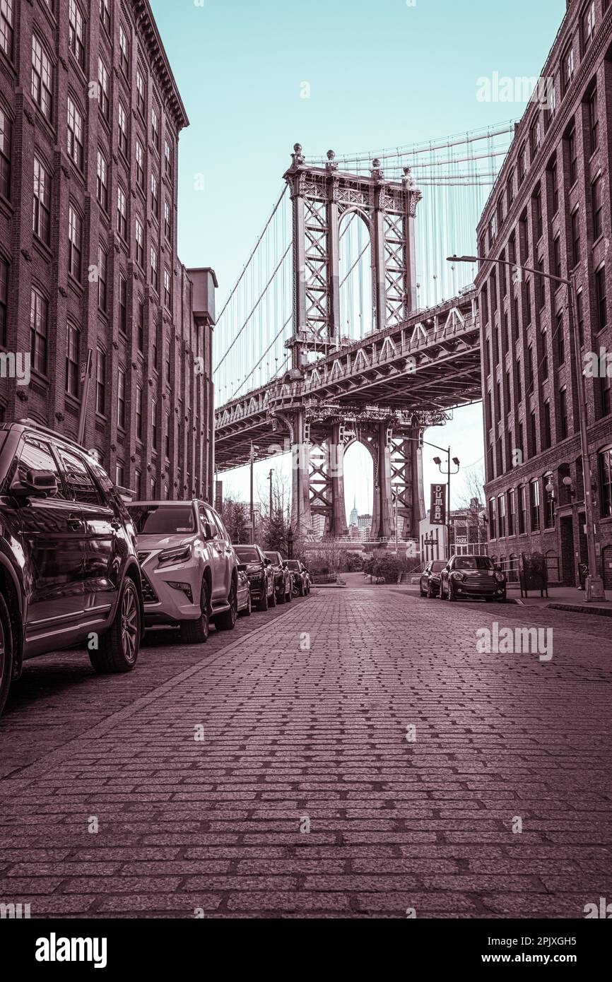 Manhattan Bridge tra due edifici all'alba Foto Stock