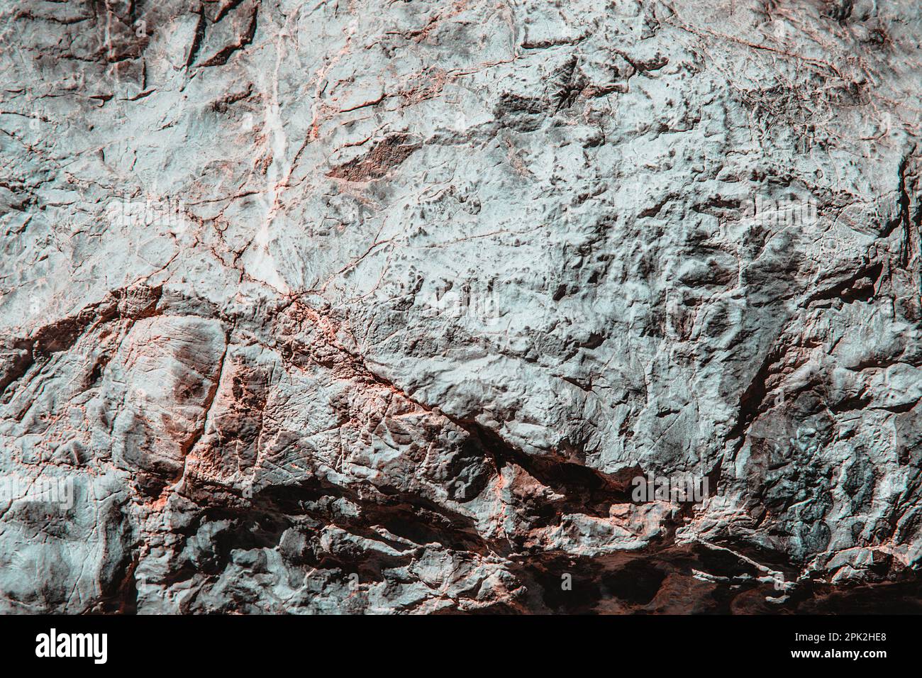 Struttura in pietra di un vecchio muro di costruzione ruvido con crepe, rilievi, trame. Modello casuale Foto Stock