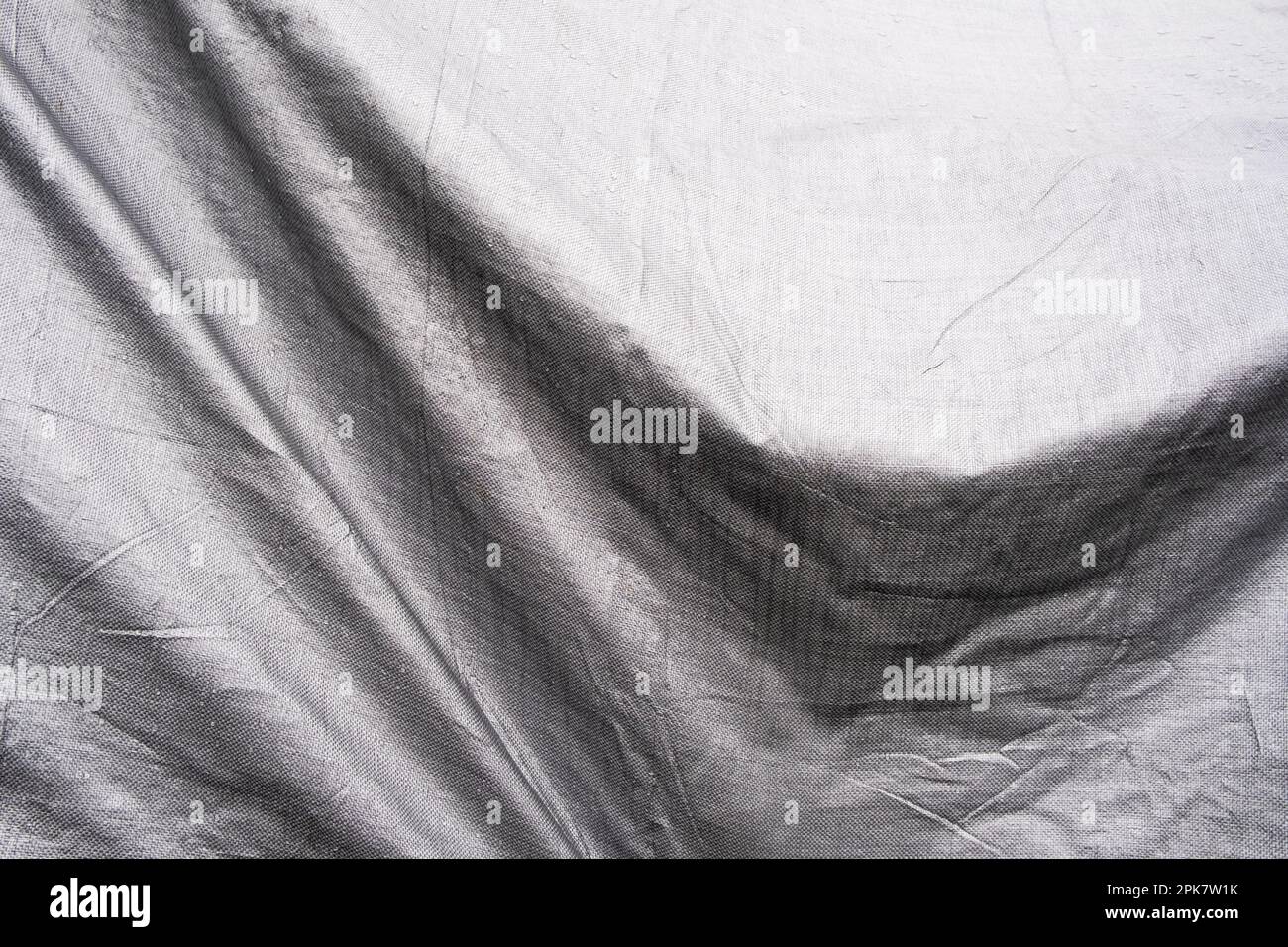 Immagine in bianco e nero, pieghe di telone drappeggiato su oggetti. Foto Stock
