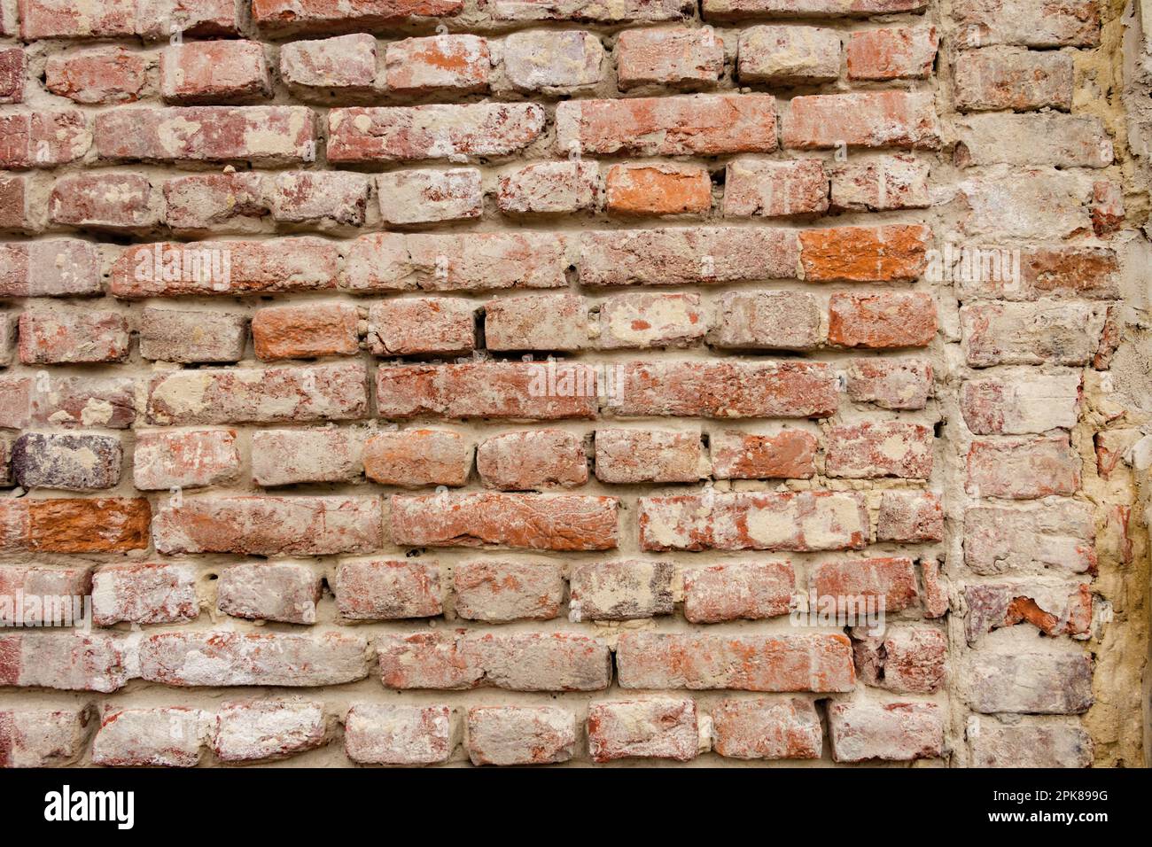 Struttura di un muro di mattoni. Vecchia muratura in mattoni arancioni testurizzati. Immagini volumetriche, foto realistiche e di alta qualità per il web design e lo sfondo Foto Stock