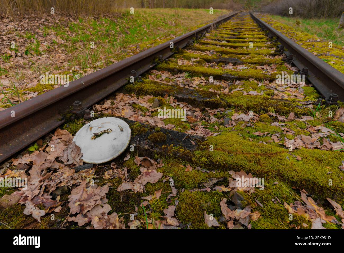 Vecchia ferrovia vicino a Berlino in Germania, il vecchio coperchio della pentola di Emallie si trova nel letto della pista Foto Stock