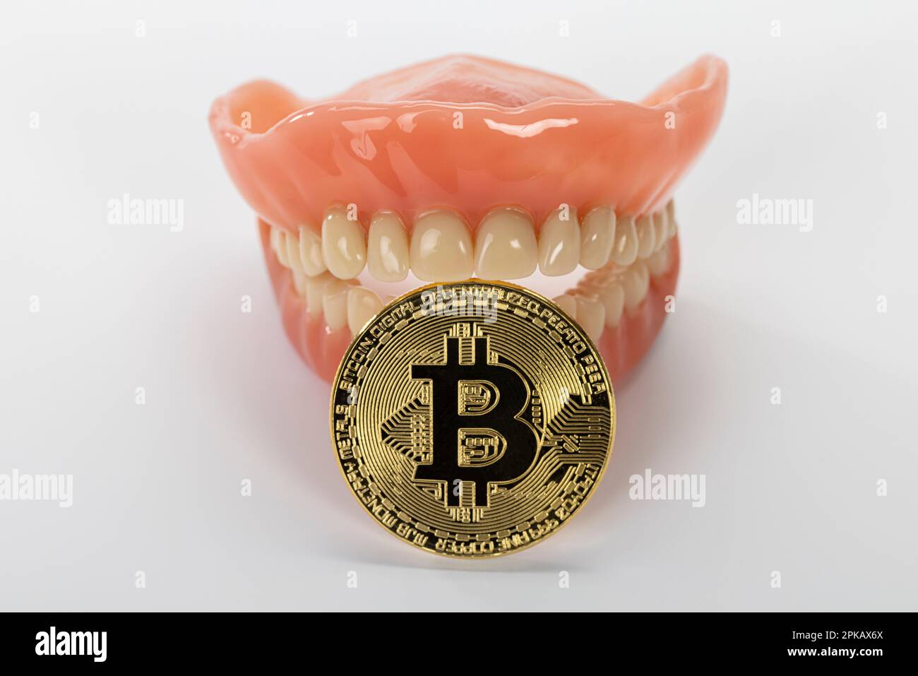 Dentiera con una moneta bitcoin, immagine simbolo, metodo di pagamento, moneta digitale, criptovaluta, sfondo bianco, Foto Stock