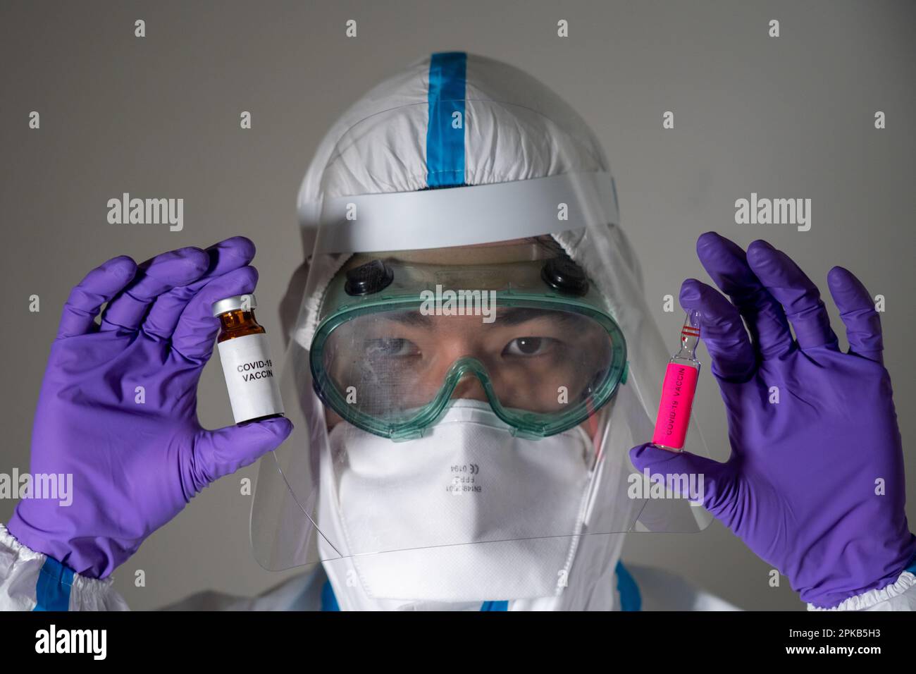 Uomo in tuta protettiva durante la pandemia di Covid-19. Foto Stock