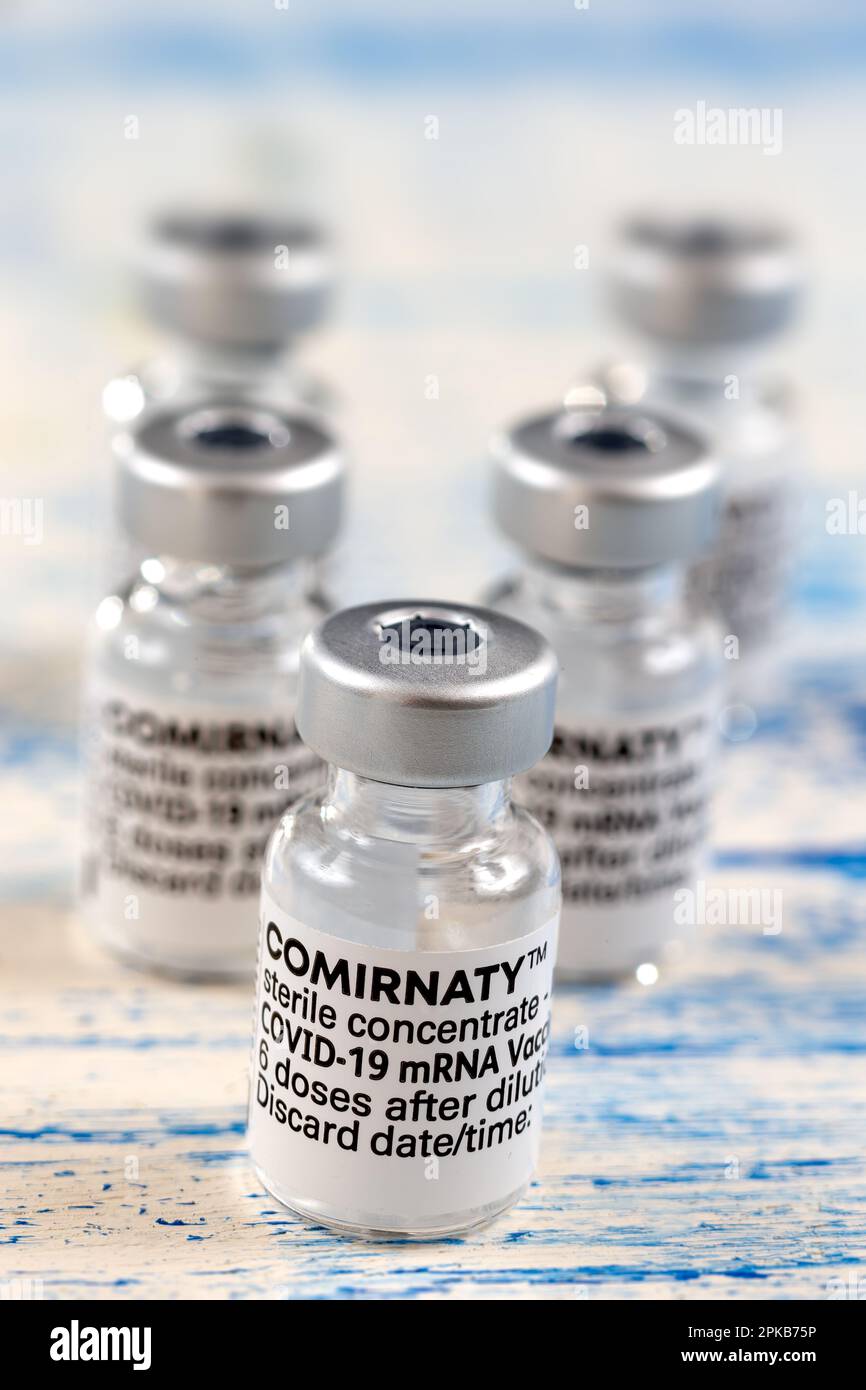 5 flaconcini di vaccino su sfondo blu. Foto Stock