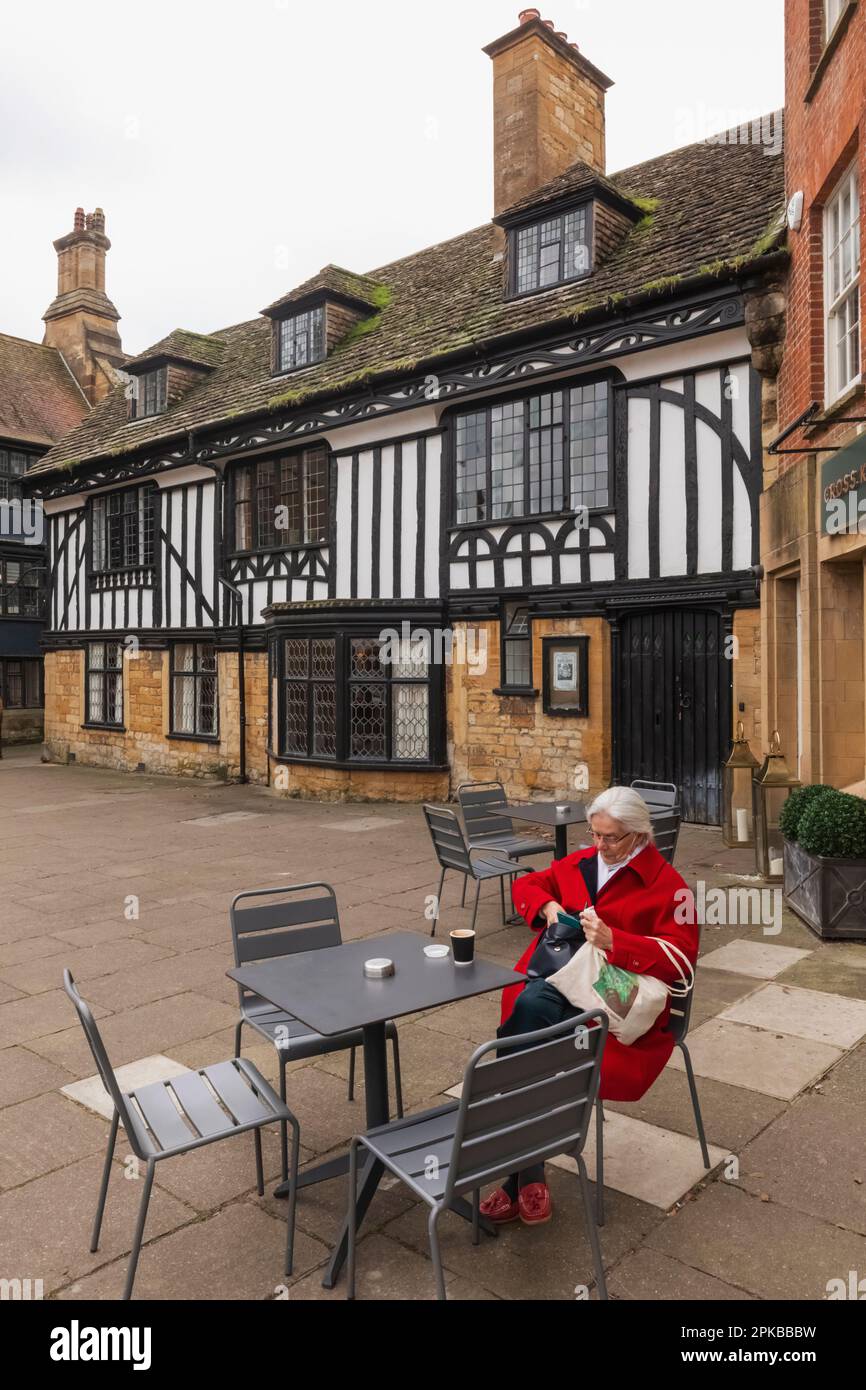 Inghilterra, Dorset, Sherbourne, Sherbourne Abbey, anziani Coffee Shop clienti e storico edificio in stile Tudor Foto Stock