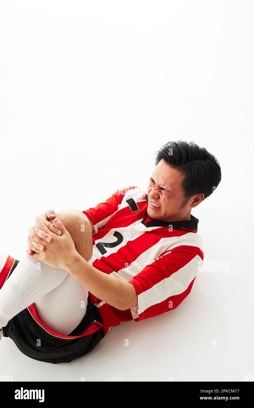 Giocatore di calcio con lesioni alle gambe Foto Stock