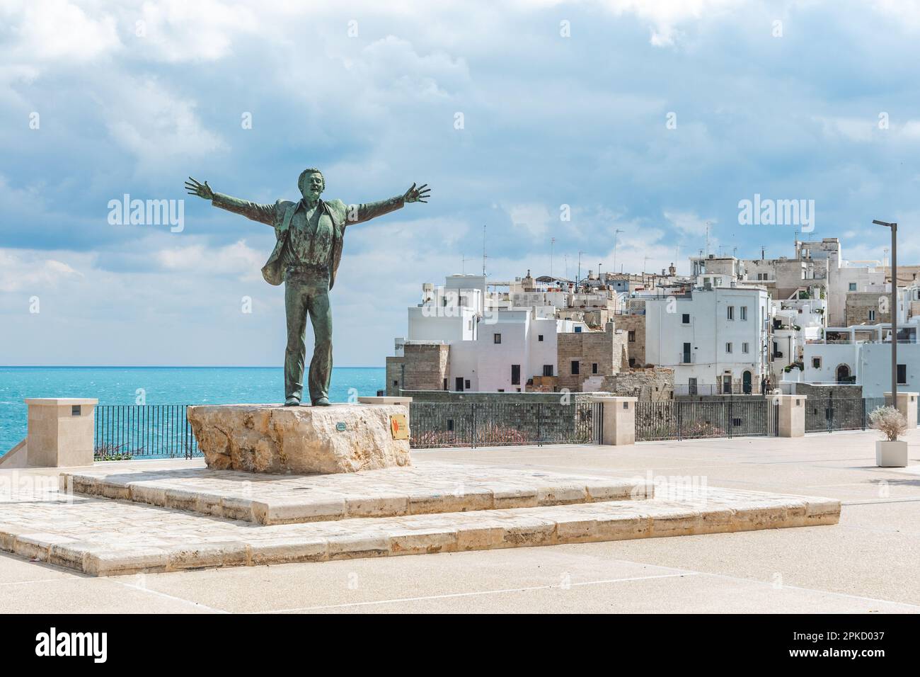 Statua in bronzo del cantante italiano Domenico Modugno che si affaccia sul centro storico sulle scogliere rocciose e sul mare blu a braccia aperte come la famosa canzone volare Foto Stock