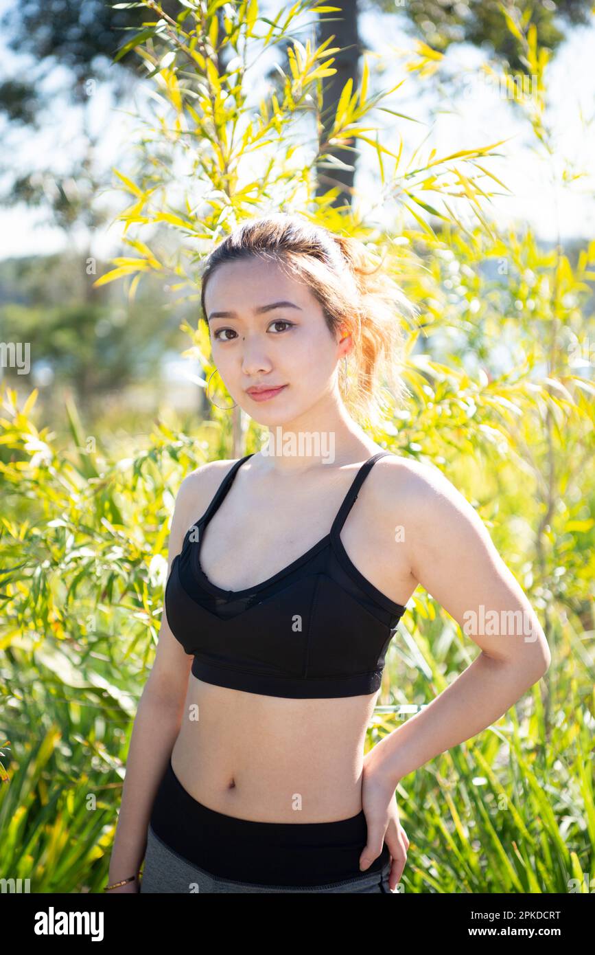 Donna in piedi in verde in abbigliamento da training Foto Stock